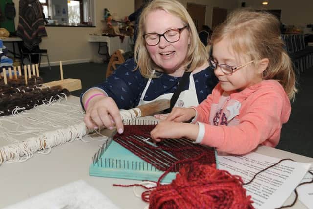 Woolly day at North Kyme Village Hall, organised by South Lincolnshire Spinner and Weavers. Liz Taylor (member) Pin Loom Weaving with Grace Maxwell 5. EMN-160330-174405001