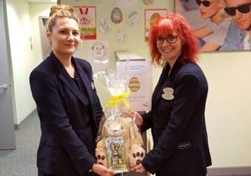 Staff at Sleaford Specsavers opticians with the prize for the colouring competition and a few of the entries so far. EMN-160330-112612001