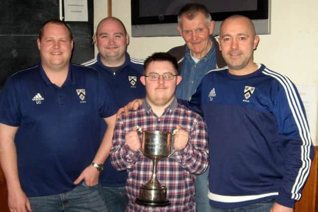 Grimsby Town supporter Josh Farrell holds the trophy at the draw with, from left, First XI captain Lee Charlton, secretary David Taylor, umpire Steve Boulton and Sean Campbell (Grimsby Second XI) EMN-160331-102910002