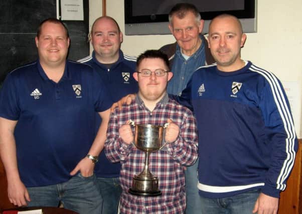 Grimsby Town supporter Josh Farrell holds the trophy at the draw with, from left, First XI captain Lee Charlton, secretary David Taylor, umpire Steve Boulton and Sean Campbell (Grimsby Second XI) EMN-160331-102910002