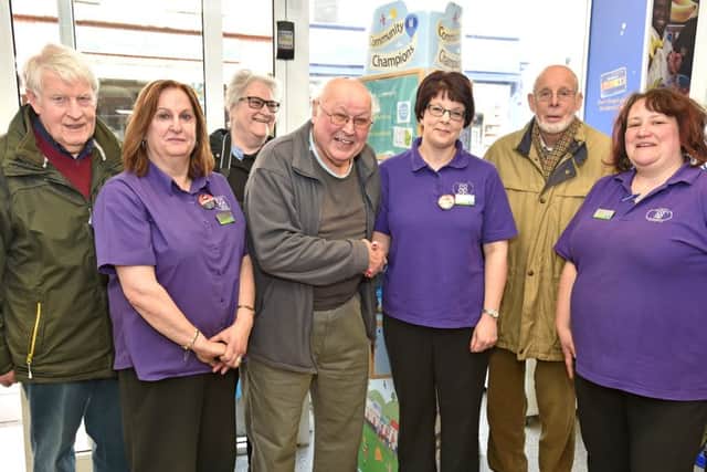 Chariman Geoff Taylor and members Maurice and Carla Temprill, and Keith Baguley receiving the Community Champion money from staff at Horncastle Co-op EMN-160804-064755001