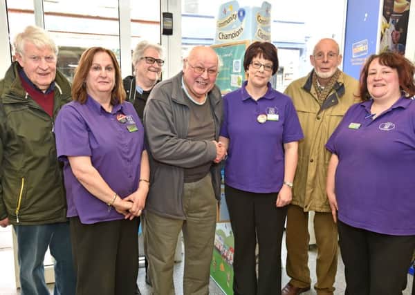 Chariman Geoff Taylor and members Maurice and Carla Temprill, and Keith Baguley receiving the Community Champion money from staff at Horncastle Co-op EMN-160804-064755001