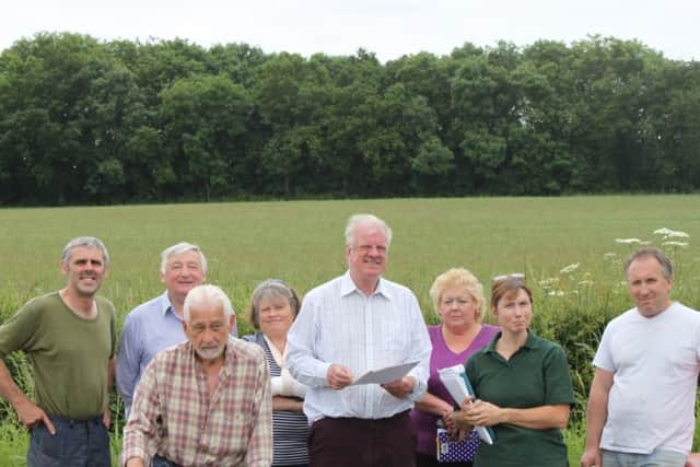 MP Sir Edward Leigh (centre) is pictured with members of Stop Turbines Action Group at the proposed site of the turbine. EMN-160704-132350001