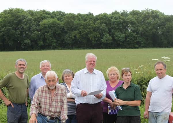 MP Sir Edward Leigh (centre) is pictured with members of Stop Turbines Action Group at the proposed site of the turbine. EMN-160704-132350001