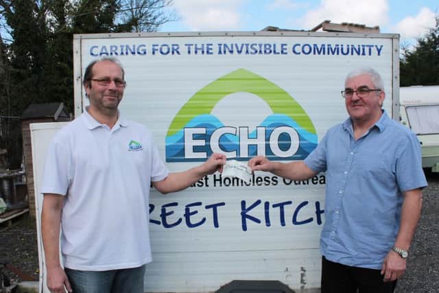 Richard Speed from ECHO (left) receives the cheque from Russell Askew from Louth Spiritualist Community Centre (right).