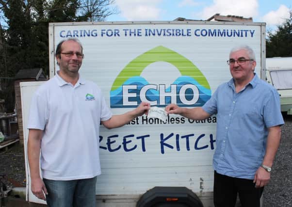 Richard Speed from ECHO (left) receives the cheque from Russell Askew from Louth Spiritualist Community Centre (right).