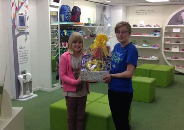 Emily Rastall, age 8, received her Easter prize from Sophie Brignall, one of the sales assistants at Clarks in Louth.