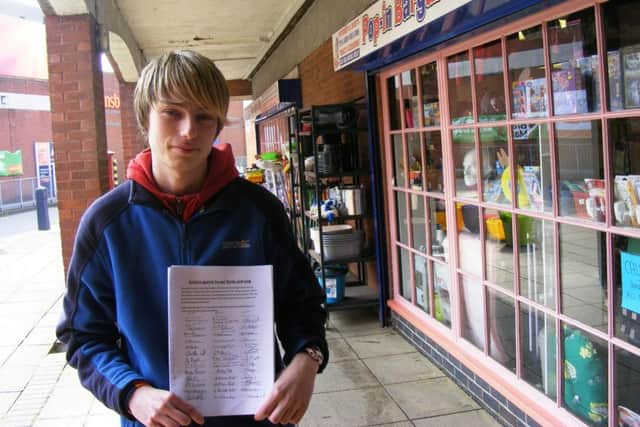 Shopkeeper Lee Taylor with the petition against aspects of the renovation. EMN-161104-161204001