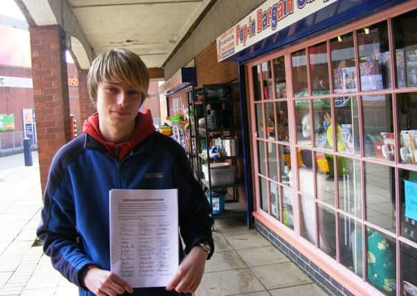 Shopkeeper Lee Taylor with the petition against aspects of the renovation. EMN-161104-161204001