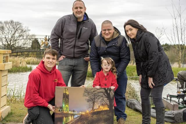 With a smaller version of the canvas donated are, from left, Jacob Davies from Lytec and Andrew Thompson of Caistor Lakes, with Isabella Clarkson, dad Colin Clarkson and mum Charlotte Clarkson. Picture taken by Bob Riach, organised the canvas and day out at Caistor Lakes.