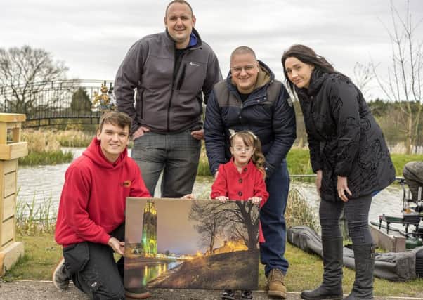With a smaller version of the canvas donated are, from left, Jacob Davies from Lytec and Andrew Thompson of Caistor Lakes, with Isabella Clarkson, dad Colin Clarkson and mum Charlotte Clarkson. Picture taken by Bob Riach, organised the canvas and day out at Caistor Lakes.