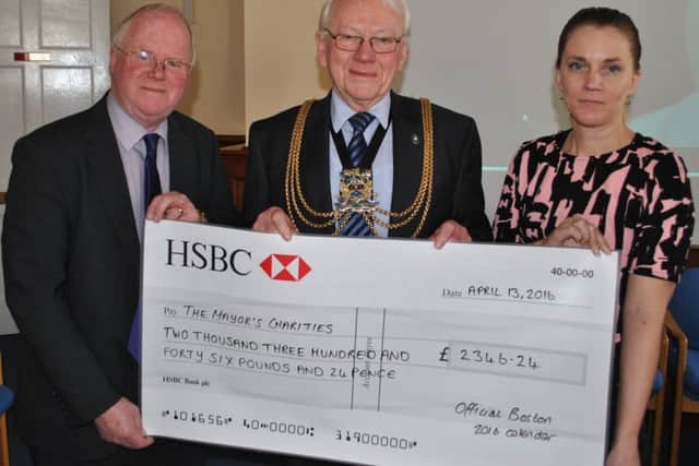Handing the cheque to Coun Austin are Andrew Malkin and Emma Staff from Boston Borough Councils communications team who designed the calendar, sought sponsors and organised printing and distribution.