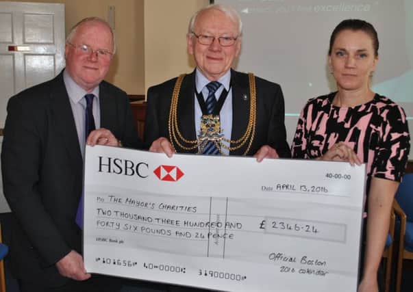 Handing the cheque to Coun Austin are Andrew Malkin and Emma Staff from Boston Borough Councils communications team who designed the calendar, sought sponsors and organised printing and distribution.