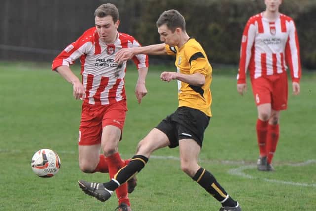Market Rasen skipper Joe Osbourne (right) disputes possession with Horncastle Town's Stephen Brown. EMN-161104-121135002