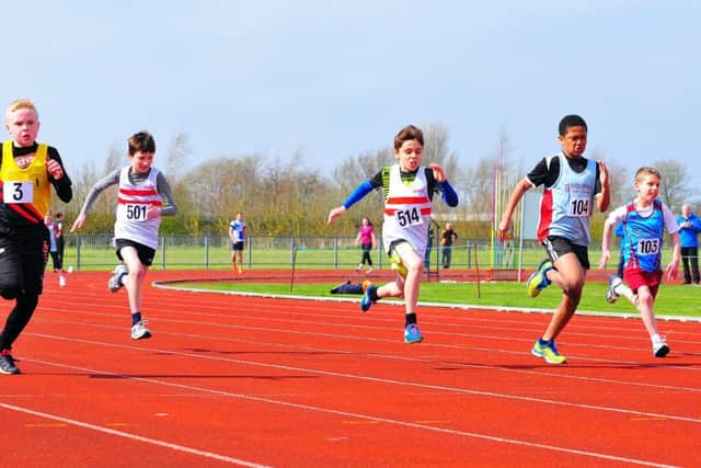 In the white vests with two red hoops of Louth AC are Declan Templeton (right) and Arthur Topham (left) in the under 11 boys' 80m race. Others pictured are Boston's Flynn Slater, Matthew Hawkridge and Owen James of Bourne Town Harriers. Photo: Graham Stephenson. EMN-161104-164043002