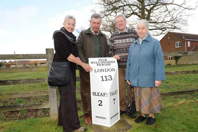 At the dedication of the restored milestone at Silk Willoughby - Sue Snart Jorgenson of Australia (left), whose great grandfather lived in the village, with from left - Bill Thackray, Paul Steer and Janet Johnson. EMN-161204-101430001