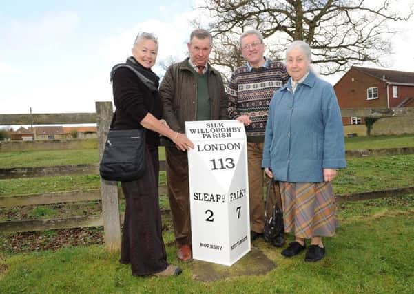 At the dedication of the restored milestone at Silk Willoughby - Sue Snart Jorgenson of Australia (left), whose great grandfather lived in the village, with from left - Bill Thackray, Paul Steer and Janet Johnson. EMN-161204-101430001