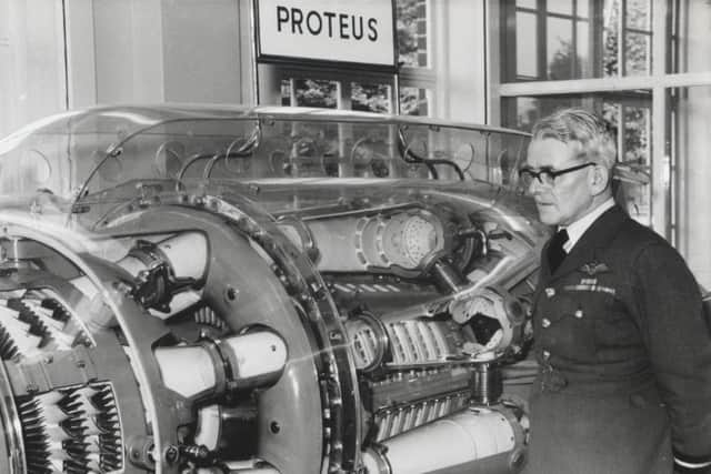 Sir Frank Whittle at the opening of Whittle Hall, inspecting the jet engine which he designed. EMN-160414-143723001