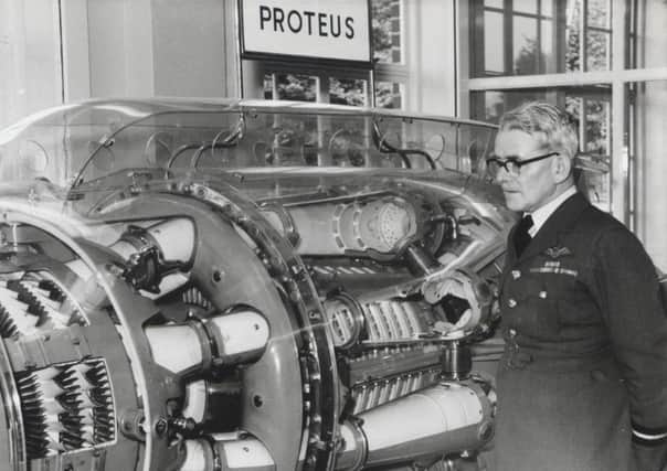 Sir Frank Whittle at the opening of Whittle Hall, inspecting the jet engine which he designed. EMN-160414-143723001