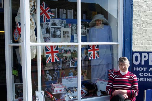 Jenny Ward pictured with her special shop window display in Donington on Bain.