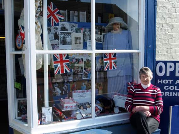 Jenny Ward pictured with her special shop window display in Donington on Bain.