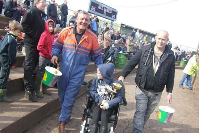 Kelsey helps to make collections for the charity on the racing track.