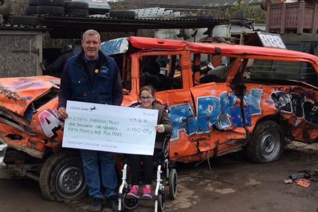 Shaun 'Starky' Stark and young Kelsey with a cheque for the £1, 150 raised for the Cystic Fybrosis Trust.
