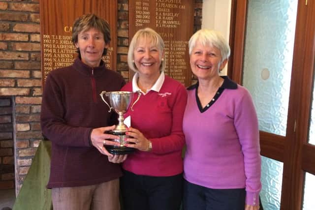 Lady Captain Anne Wallhead (centre) is pictured presenting the Suzanne Cooper Cup to Ruth Simpson and Janet Reid.
