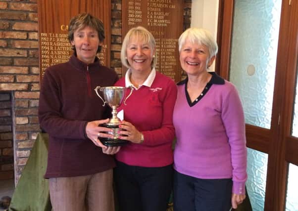 Lady Captain Anne Wallhead (centre) is pictured presenting the Suzanne Cooper Cup to Ruth Simpson and Janet Reid.