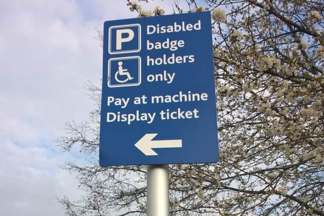 'Disabled badge holders only' parking sign.