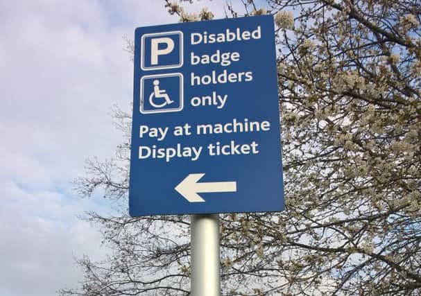 'Disabled badge holders only' parking sign.