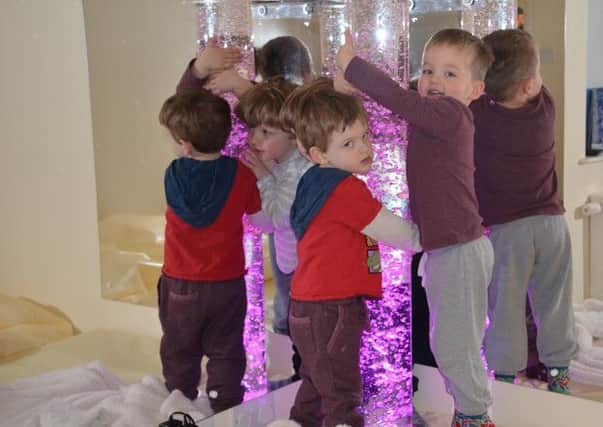 Thomas, Sam and Harrison playing in the new Sensory Room. EMN-160422-175027001