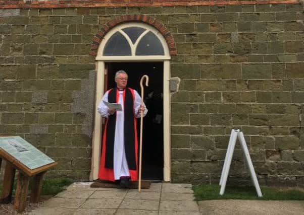 Reverend David Court, Bishop of Grimsby, at the church door EMN-160426-160416001
