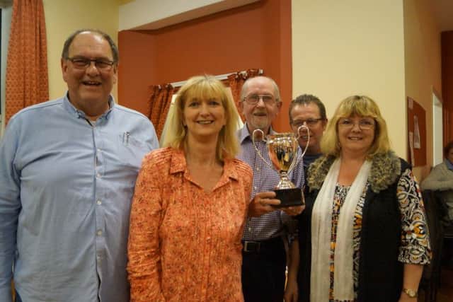 Binbrook Annual Quiz winners The Frompsons receive their trophy from quizmaster Doug Spivey EMN-160426-151600001