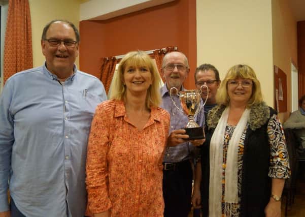 Binbrook Annual Quiz winners The Frompsons receive their trophy from quizmaster Doug Spivey EMN-160426-151600001