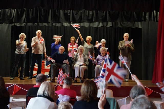 There was plenty of flag waving at the sing-a-long led by the U3A Singing GroupEMN-160425-162857001