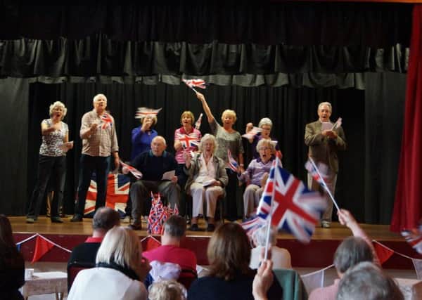 There was plenty of flag waving at the sing-a-long led by the U3A Singing GroupEMN-160425-162857001