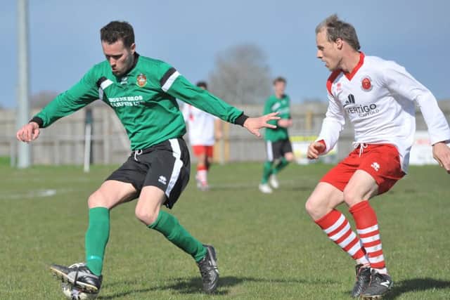 Sleaford's Craig Wells (left) comes under pressure from Arron Scutt. Photo: Nigel West