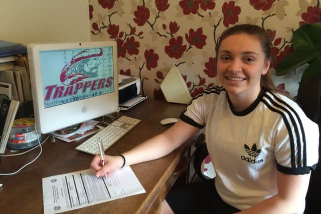 Jessica Machin signs her contract with her Wyoming-based college.