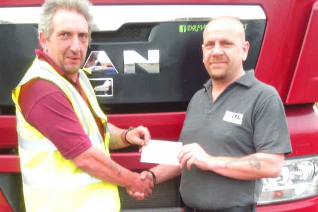 Trucking book writer Neil Donner (left) receives sponsorship for the 2017 charity calendar from Fred Flatters of Mountains Skip Hire. EMN-160428-131957001