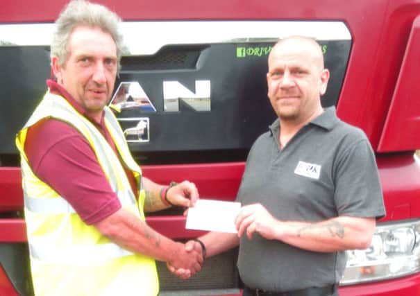 Trucking book writer Neil Donner (left) receives sponsorship for the 2017 charity calendar from Fred Flatters of Mountains Skip Hire. EMN-160428-131957001