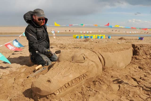 Sand sculptor Jamie Wardley.creating an alligator at th sand sculpting workshops held on Central Beach in Skegness. ANL-160205-104748001
