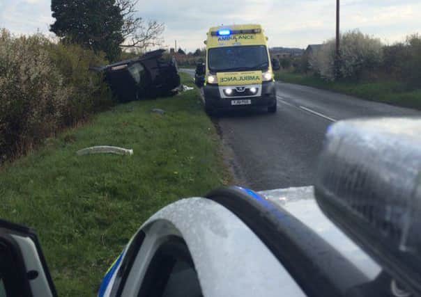 Police and ambulance on the scene after a car rolled onto its side on Mareham Lane, Spanby, yesterday evening (Wednesday). EMN-160428-130557001