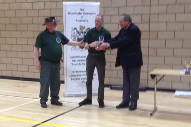 Stuart Rodgers, with Louth club chairman Rick Smith (left), receives his national trophy from Chris Brown of sponsors, the Worshipful Company of Fletchers EMN-160428-132507002