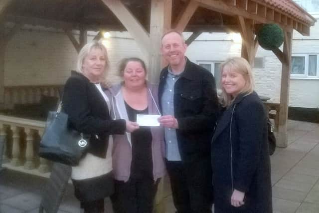 Landlady Sharon Davies and promotor Darren Dodds present the cheque to Yvonne Andrews and Sarah Dodds from LouthXSports.