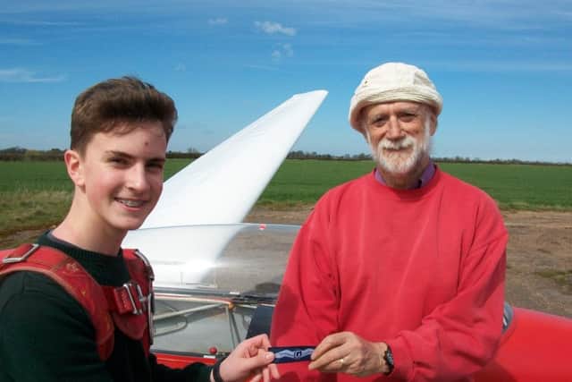 Ethan Scott is pictured receiving his wings from and congratulations from chief flying instructor, Dick Skerry.