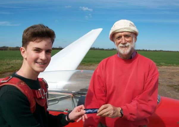 Ethan Scott is pictured receiving his wings from and congratulations from chief flying instructor, Dick Skerry.