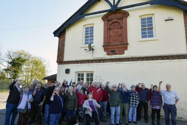 Delighted villagers outside The New Plough in Covenham St Bartholomew.