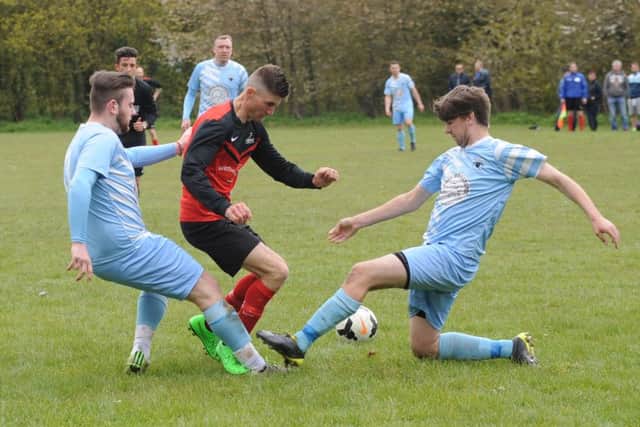 Friskney's Victor Sibert battles with Leverton's Chase Maddison and Joe Money.