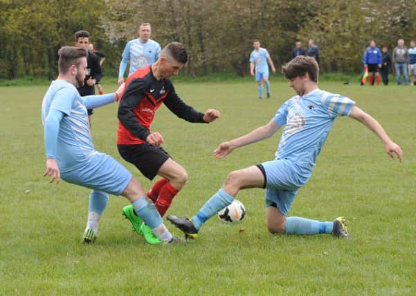 Friskney's Victor Sibert battles with Leverton's Chase Maddison and Joe Money.